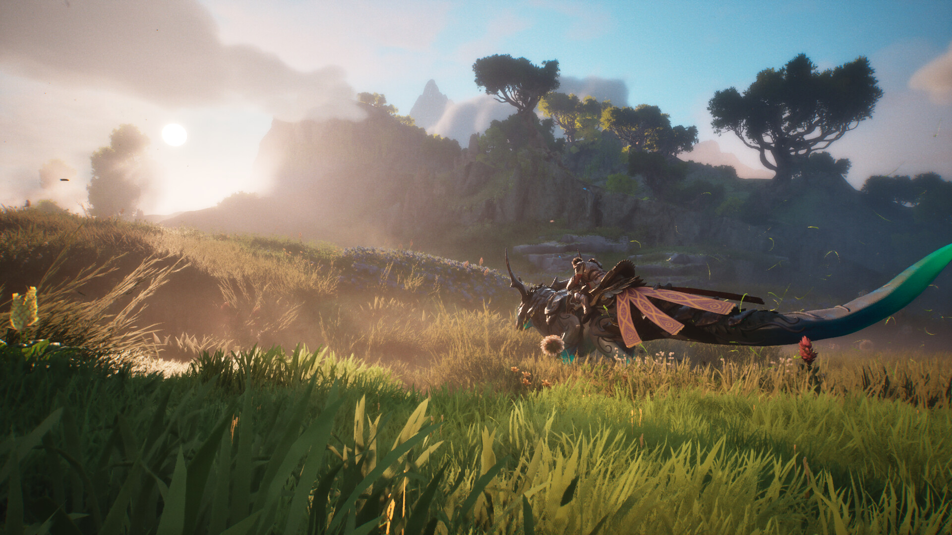 A horned mount rests in tall grass on a sunlit hillside